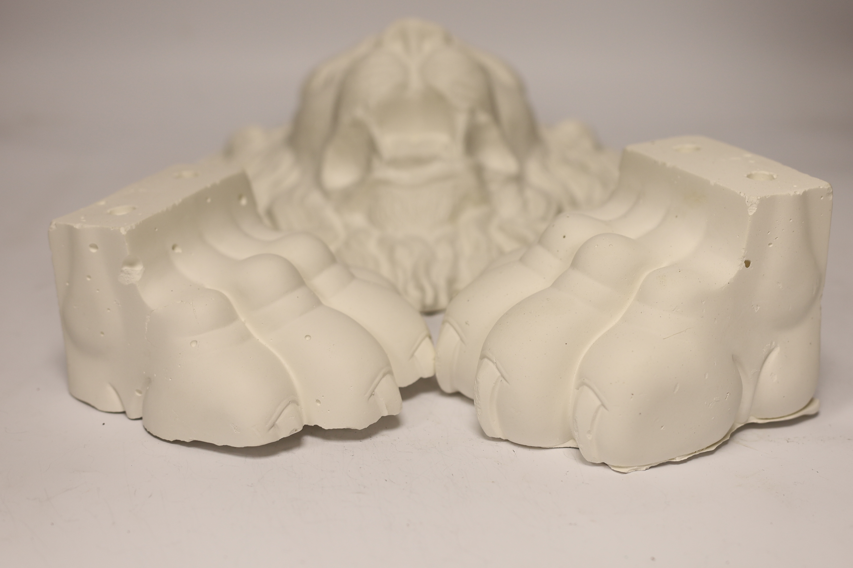 A plaster griffin Roman lion and a pair of lion paws